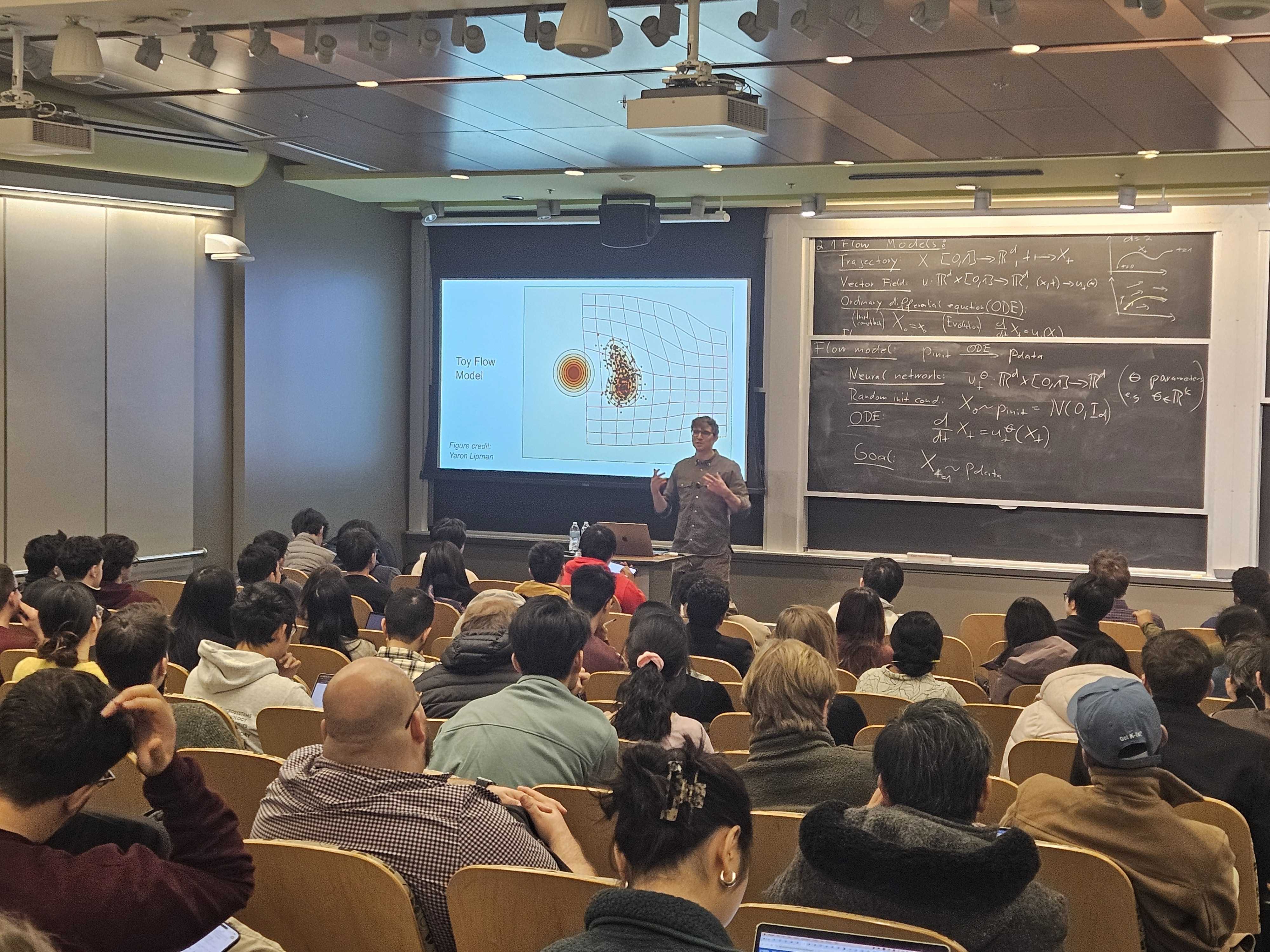 Lecturing on flow models to a full classroom at MIT